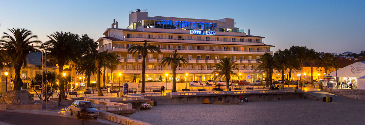 Night view of Hotel Baia in Cascais with beach in forefront