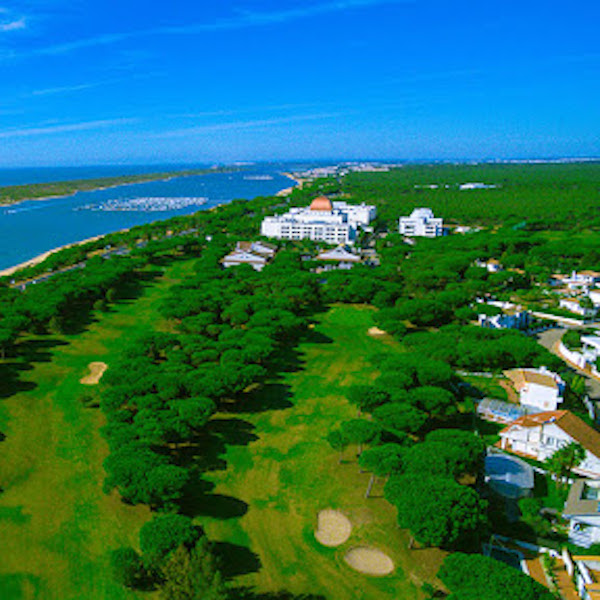 View of the golf course and sea and Nuevo Portil Hotel