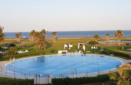 View of the pool and sea from Parador del Malaga Golf