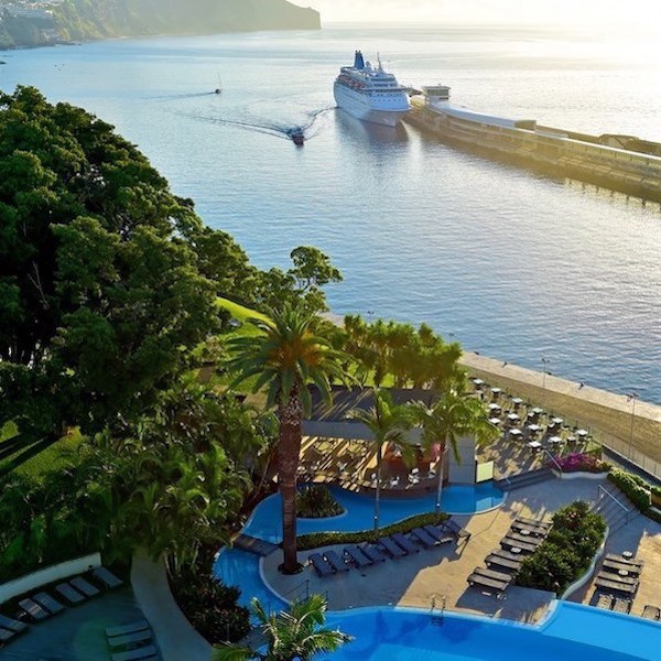 Pool view of Pestana Casino Park Hotel and cruise ship in the distance