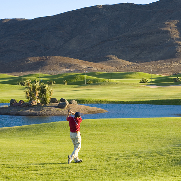 Golfer hits fairway shot on Playitas Golf, Fuerteventura