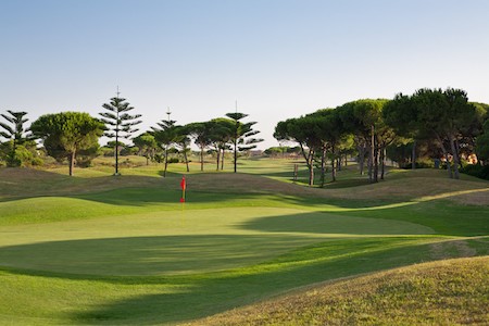 Green backed by umbrella pines on Sancti Petri Hills Golf