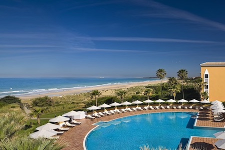 View of the pool and the beach from the hotel