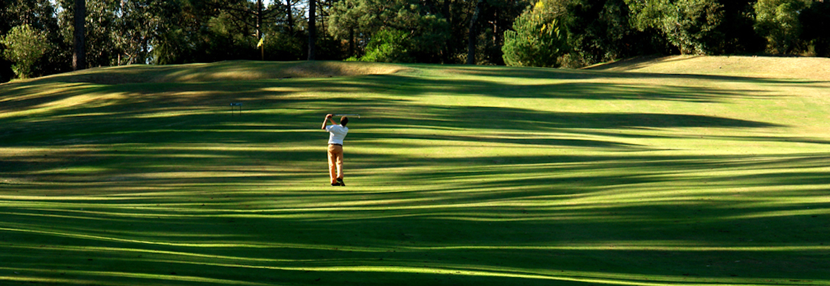 Pitching to the green from the shadows on the fairway on the 7th hole at Lisbon Sports Club