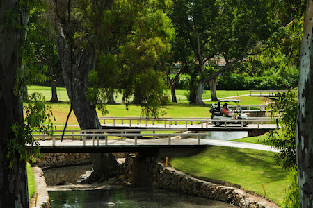 Golf buggy travels over a bridge at Los Naranjos Golf