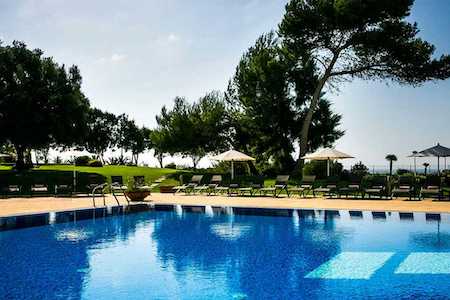 Pool, chairs and umbrellas welcome guests