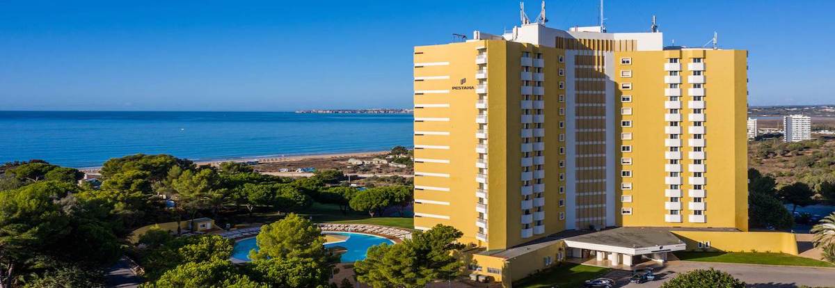 View of the ocean, beach and pool area at the Pestana Delfim Hotel